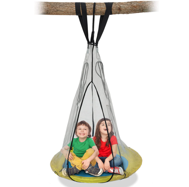 2 kids sitting on a saucer round swing hanging from a tree branch